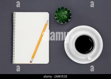 Blank notepad and coffee cup, conceptual minimalism. Stock Photo