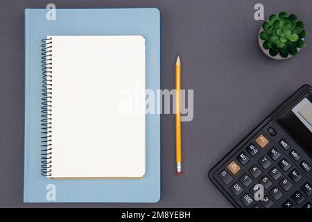 Blank notepad, calculator and pencil, top view. Stock Photo