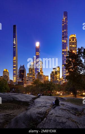 Central Park in evening with view of the skyscrapers of Billionaires' Row. Midtown Manhattan, New York City Stock Photo