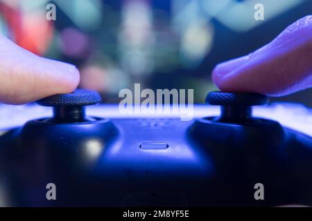 Gamer playing game with controller Stock Photo