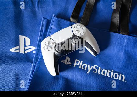 Bangkok, Thailand - December 27, 2022: Playstation 5's DualSense game controller and Playstation logo. Stock Photo