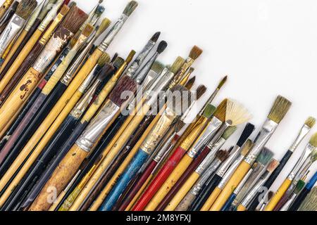 Many brushes for painting on a white background, top view. Stock Photo
