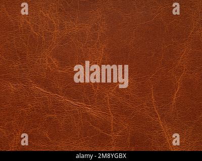 Genuine luxury orange, red, brown leather texture sample. Background with copy space. Faux eco leather. Textured backdrop effect for design Stock Photo