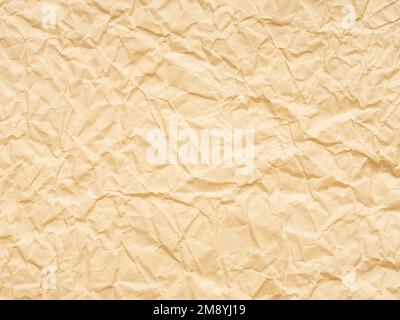 Extra soft beige or yellow crumpled paper texture. Blank grunge page or sheet for interior and exterior decoration. Empty background for handcrafts Stock Photo