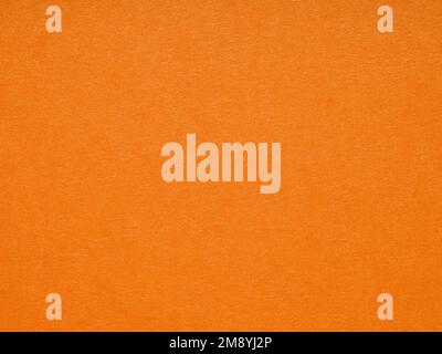 Metallized orange soft matt paper background. Blank page pattern of designer cardboard. Texture for making winter season Christmas festival card sheet Stock Photo