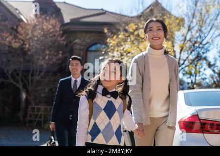 A young couple pick up the kids from school Stock Photo