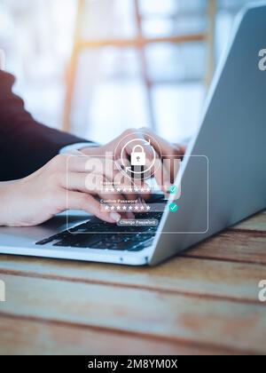 Reset password concept. Lock icon, security code showing on change password page while business person using laptop computer, vertical style. Cyber se Stock Photo