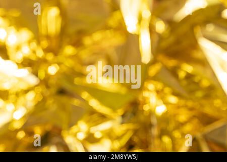 defocused crumpled gold foil, fashion texture background Stock Photo