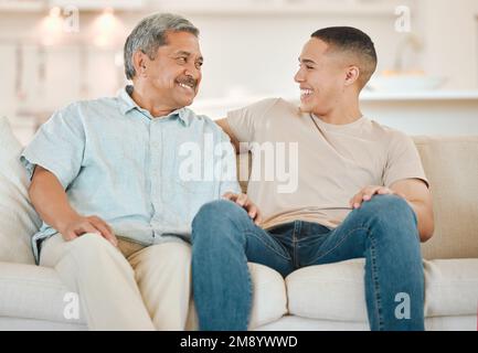Is that how it goes. a father and son bonding on the sofa at home. Stock Photo
