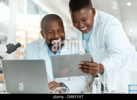 Thats what we were looking for. two scientists using a laptop and digital tablet in a laboratory. Stock Photo