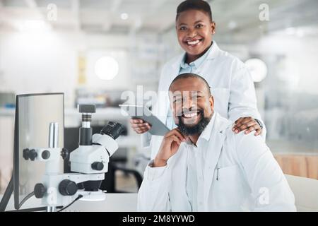 You have to be very precise when working with samples. two scientists using microscopes in a lab. Stock Photo