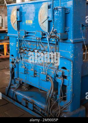 Press machine in the factory workshop, vertical format. Metalworking equipment. Concept of metalworking technology Stock Photo