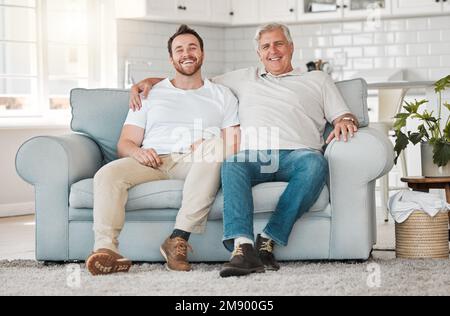 Rejoice with your family in the beautiful land of life. a father and son sitting on the sofa at home. Stock Photo