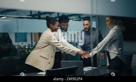 Multiracial business team group of workers developers managers looking at laptop in office celebrating success victory good news put palms up Stock Photo