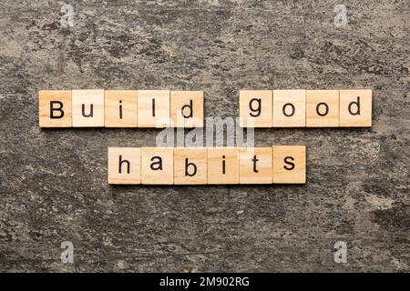 Build good habits word written on wood block. Build good habits text on table, concept. Stock Photo