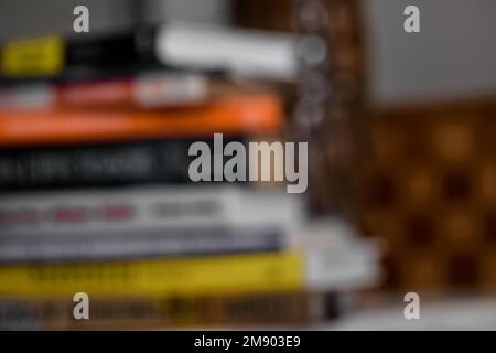 blurred background of stack of books on desk Stock Photo
