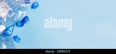 a lot of plastic empty rumpled used bottles on a blue background. waste and pollution concept. Stock Photo