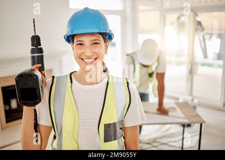 Which room should I start in. an attractive young construction worker standing inside and holding a power drill. Stock Photo