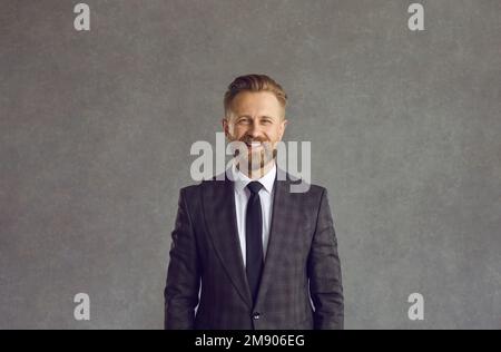 Portrait of confident smiling businessman wearing formal suit posing for camera Stock Photo