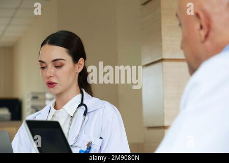 Team doctor talking and discussing about surgery treatment patient’s case while sitting in the meeting room office in hospital. healthcare and medical Stock Photo