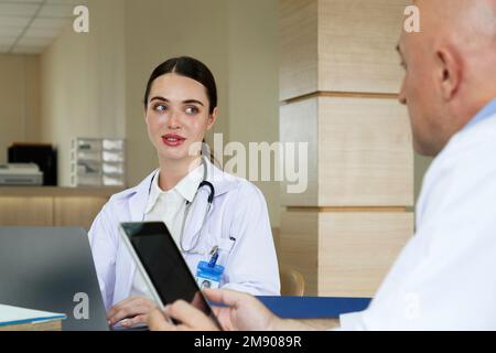 Team doctor talking and discussing about surgery treatment patient’s case while sitting in the meeting room office in hospital. healthcare and medical Stock Photo