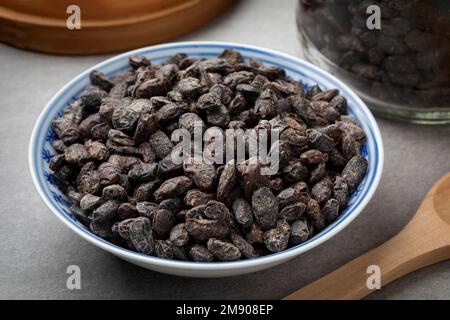 Bowl with Chinese salted black beans as an ingredient close up Stock Photo