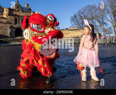 Edinburgh, United Kingdom. 16 January, 2023 Pictured: L to R Chinese Dragon and Luna Chen (5 years old). Organisers of Edinburgh’s Chinese New Year Festival announce a full programme of events and activities across the city to celebrate Chinese New Year and the start of The Year of the Rabbit.   Stock Photo