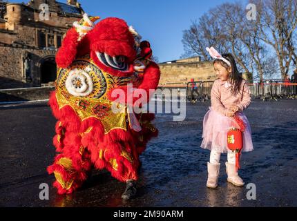 Edinburgh, United Kingdom. 16 January, 2023 Pictured: L to R Chinese Dragon and Luna Chen (5 years old). Organisers of Edinburgh’s Chinese New Year Festival announce a full programme of events and activities across the city to celebrate Chinese New Year and the start of The Year of the Rabbit.   Stock Photo