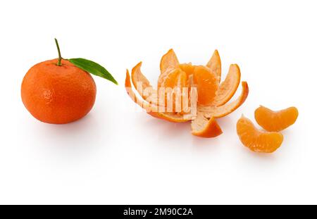 Ripe tangerine with green leaf next to peeled tangerine with mandarin wedges, isolated on white with clipping path Stock Photo