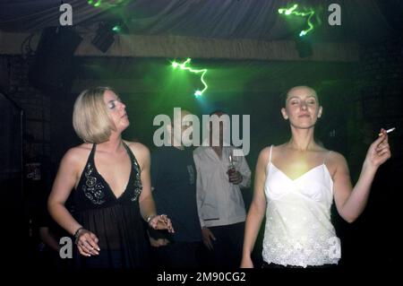 Dancers at LEROY THORNHILL (DJ/Ex-PRODIGY) at the EMPORIUM CLUB in Cardiff, May 15 2003. Photograph © ROB WATKINS  Both girls smoking Stock Photo
