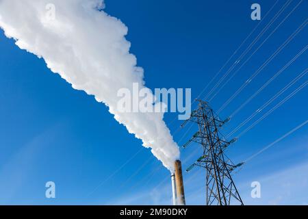 Smoking chimneys and the power line. Stock Photo