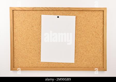 closeup of thumbtack and note on billboard Stock Photo