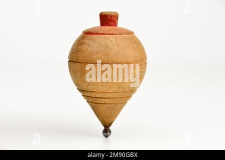 Old wooden spinning top on against a white background Stock Photo