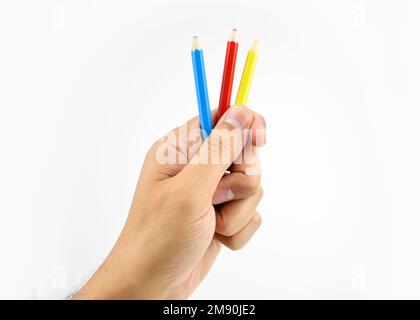 Shot of a hand and crayons against a white background Stock Photo
