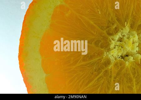 Close-up of fresh orange slice on white background. Slice of orange  in sparkling water on white background, close-up. Horizontal image. Stock Photo