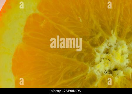 Close-up of an orange slice in liquid with bubbles. Slice of orange fruit in water. Close-up of fresh orange slice covered by bubbles. Stock Photo