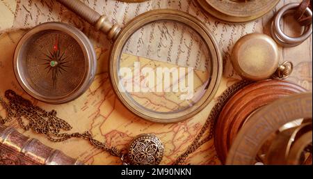Vintage style travel and adventure. Vintage old compass and other vintage items on the table. Stock Photo