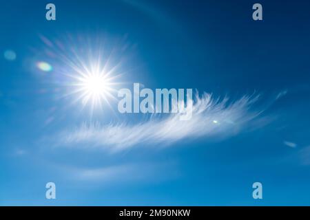 Clouds in the blue sky. Bright midday sun illuminates the space. Stock Photo