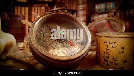 Vintage style travel and adventure. Vintage old compass and other vintage items on the table. Stock Photo
