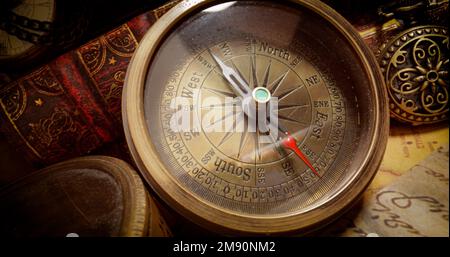 Vintage style travel and adventure. Vintage old compass and other vintage items on the table. Stock Photo