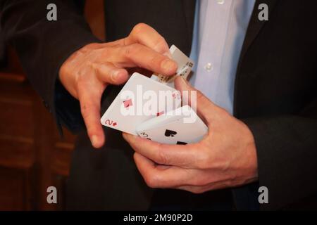 Man performing a card trick Stock Photo
