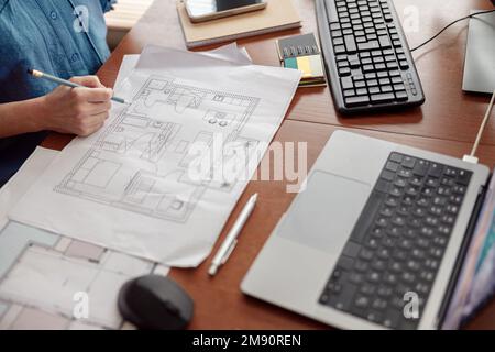Woman engineer construction is developing construction project documentation sitting at home office Stock Photo
