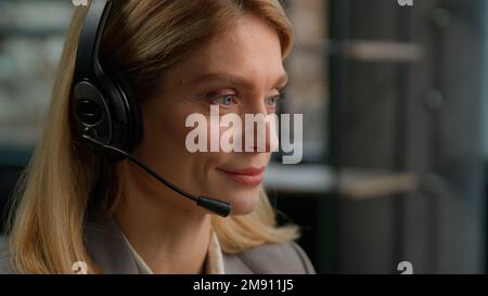 Call center customer service female worker middle aged woman in headset talking to client distant consultation Caucasian adult helpline manager Stock Photo