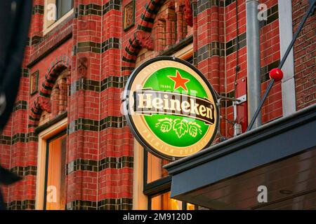 Arnhem, The Netherlands - December 12, 2022: Outdoor sign of Heineken beer brewery on the wall of a bar in Arnhem, The Netherlands Stock Photo