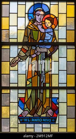 TASCH, SWITZERLAND - JULY 2, 2022: The stained glass with the St. Anthony of Padua in the parish church designed by August Wanner Stock Photo