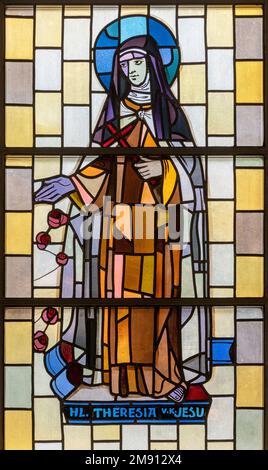 TASCH, SWITZERLAND - JULY 2, 2022: The stained glass with the St. Therese of the Child Jesus in the parish church designed by August Wanner Stock Photo