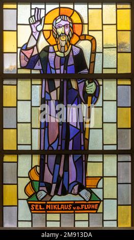 TASCH, SWITZERLAND - JULY 2, 2022: The stained glass with the St. Nicolas of Flue in the parish church designed by August Wanner Stock Photo