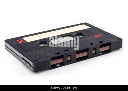 Audio cassette tape - old vintage compact audio cassette on its side isolated on white background, bottom view Stock Photo