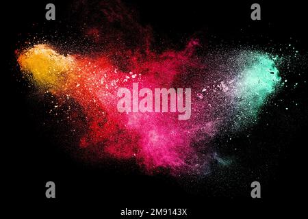 Launch brown particles exploding on black background, brown dust splashing Stock Photo