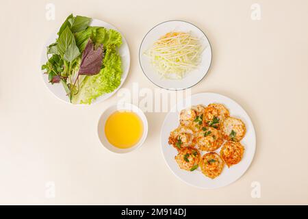 Banh khot Vung Tau, Vietnamese mini savory pancakes with with rice batter and shrimp, vietnamese food isolated on white background, top view Stock Photo
